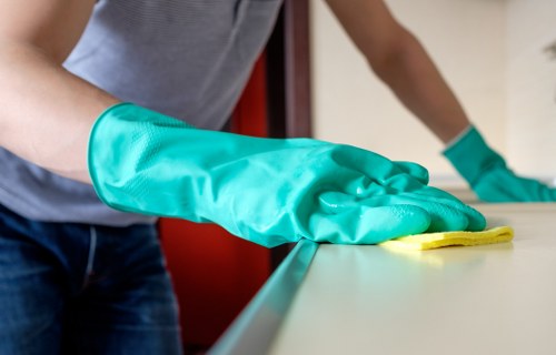 Cleaner using protective gear while handling cleaning product